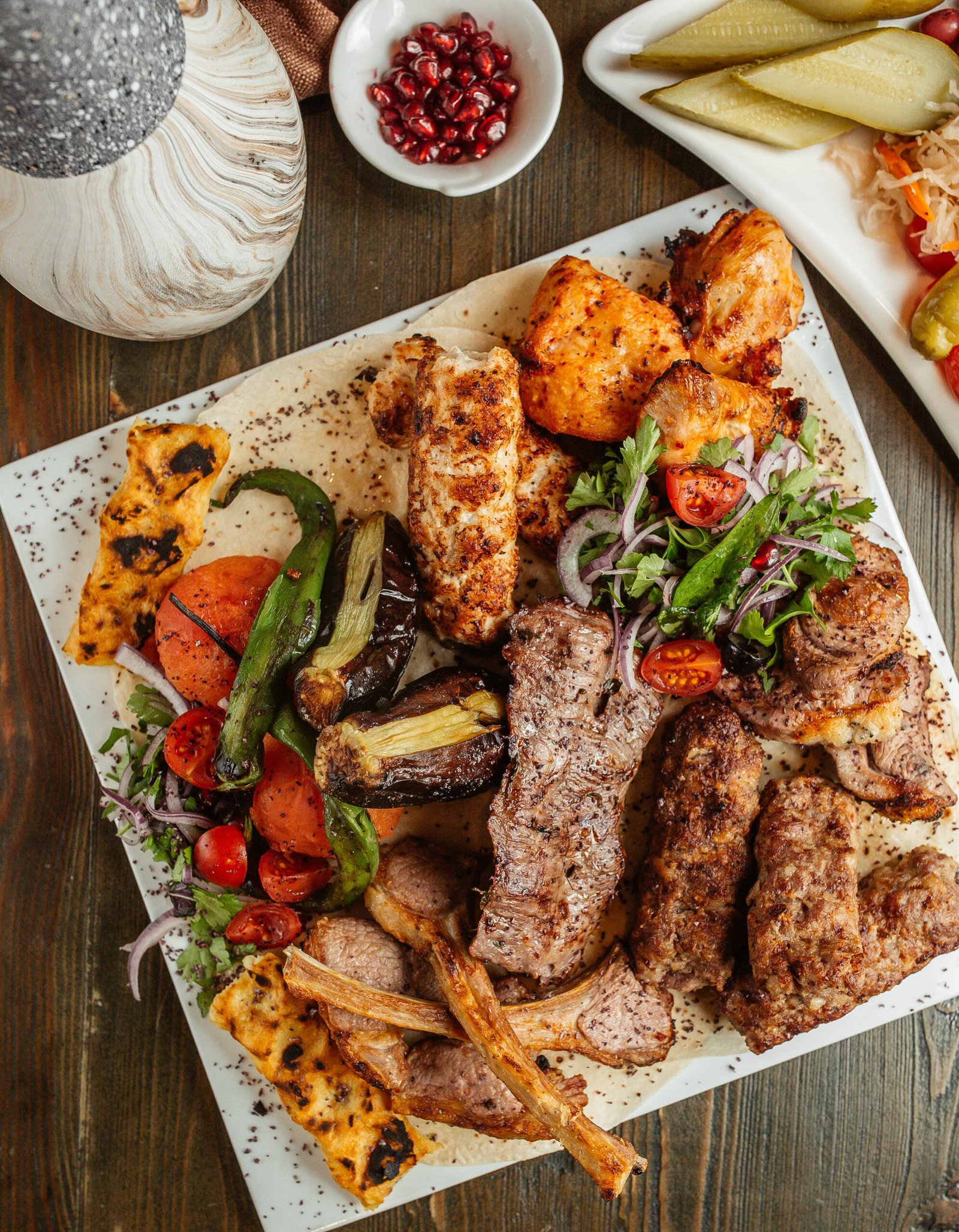top view of kebab platter with ribs chicken lula tikka and vegetables kebab